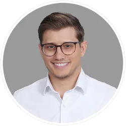 Portrait of Ventures smiling, wearing glasses and a white shirt